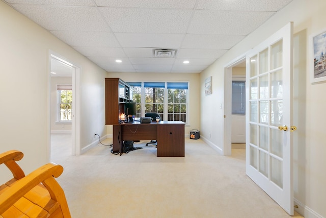 carpeted home office with a paneled ceiling and plenty of natural light