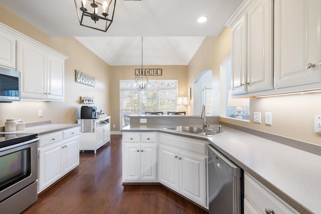 kitchen featuring sink, white cabinetry, decorative light fixtures, appliances with stainless steel finishes, and dark hardwood / wood-style floors