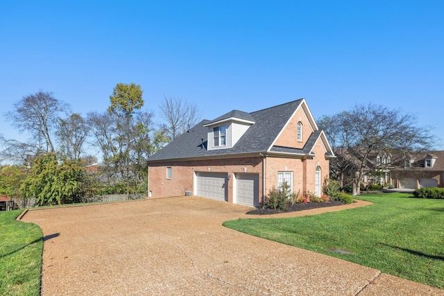 view of side of property with a garage and a lawn