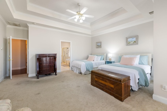 carpeted bedroom featuring crown molding, ceiling fan, a tray ceiling, and ensuite bath