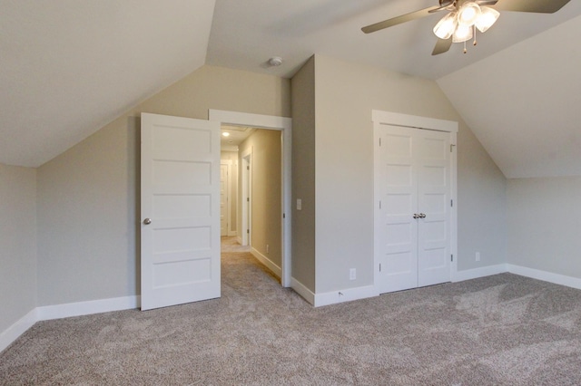 additional living space featuring light carpet, lofted ceiling, and ceiling fan