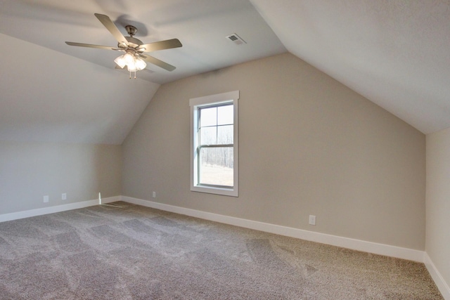 additional living space with ceiling fan, light colored carpet, and lofted ceiling