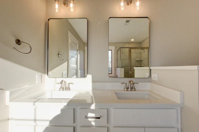 bathroom with vanity and a shower with door