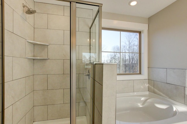 bathroom featuring separate shower and tub