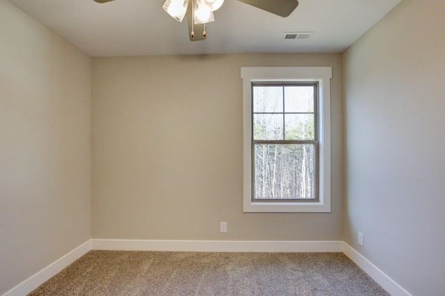 unfurnished room featuring ceiling fan and light carpet