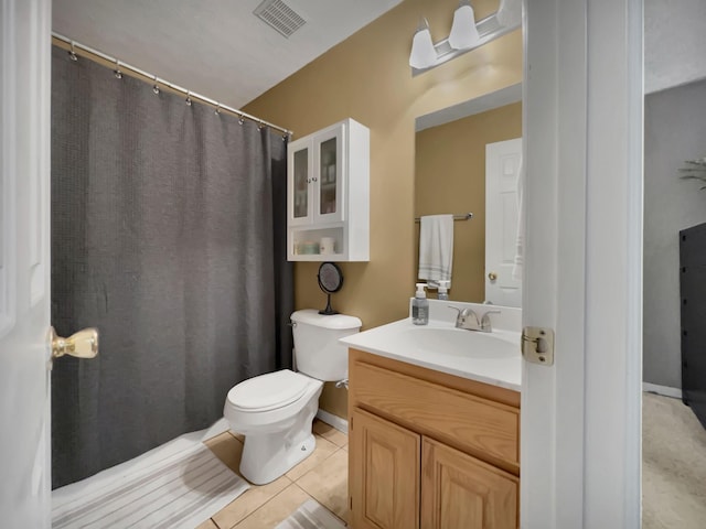 bathroom featuring vanity, tile patterned floors, and toilet