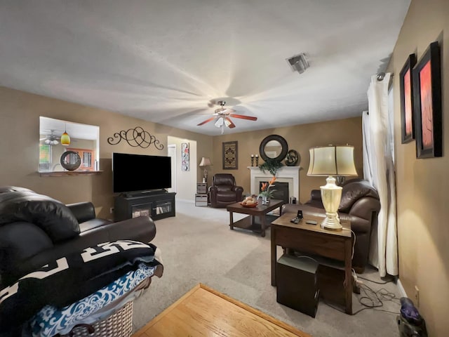 carpeted living room featuring ceiling fan