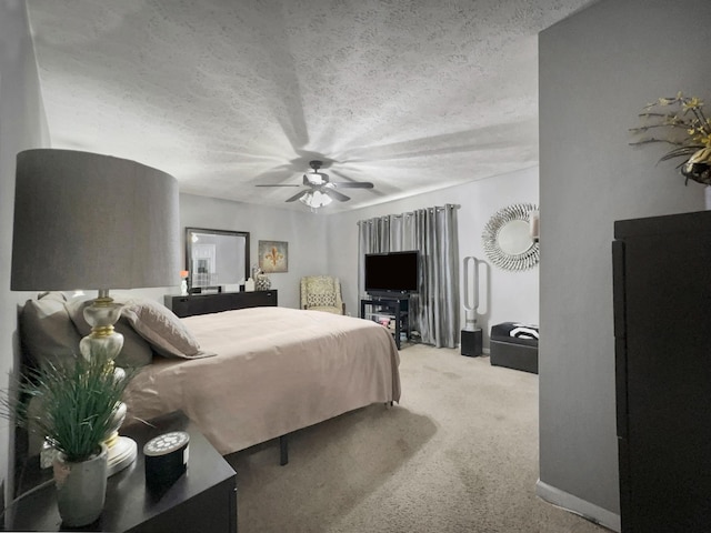 carpeted bedroom with a textured ceiling and ceiling fan