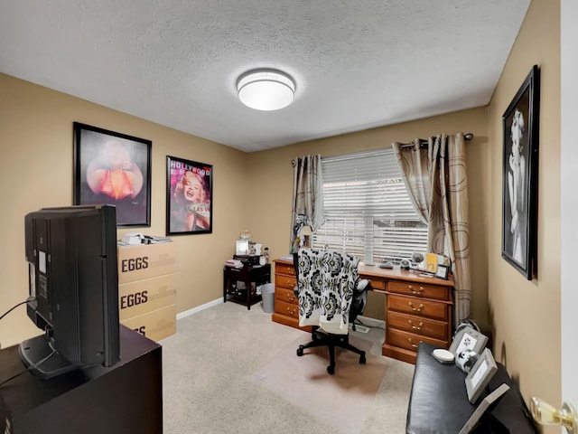 carpeted office space featuring a textured ceiling