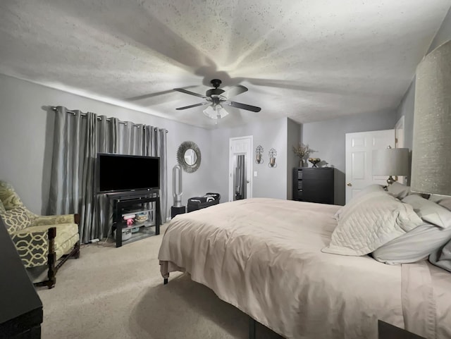 carpeted bedroom with a textured ceiling and ceiling fan