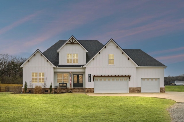 view of front facade featuring french doors and a yard