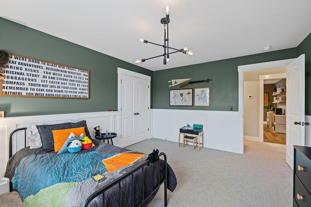 bedroom featuring carpet flooring and a notable chandelier