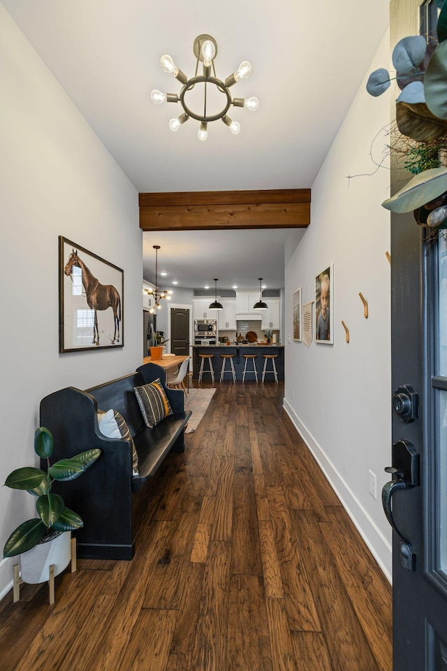 living room with beamed ceiling, dark hardwood / wood-style floors, and a notable chandelier