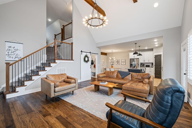 living room featuring a barn door, dark hardwood / wood-style flooring, high vaulted ceiling, and a notable chandelier