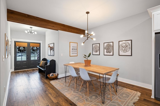 dining room with beamed ceiling, dark wood-type flooring, an inviting chandelier, and french doors