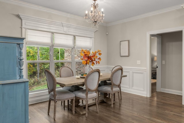 dining area with ornamental molding, dark hardwood / wood-style floors, and a notable chandelier