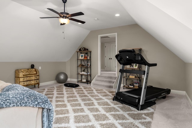 workout area featuring ceiling fan, lofted ceiling, and carpet flooring