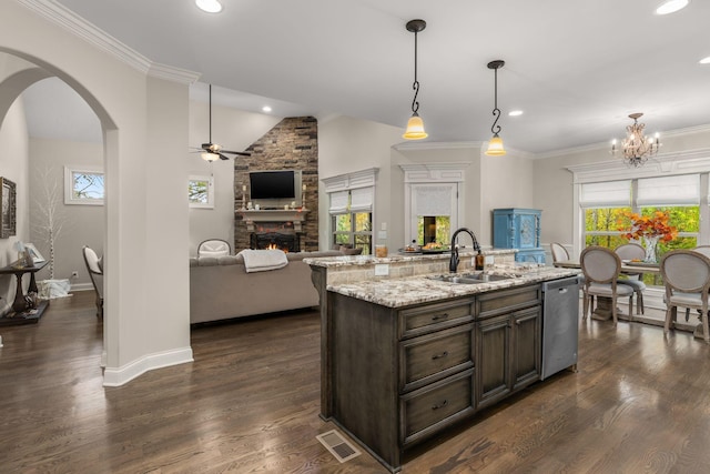 kitchen with dishwasher, sink, hanging light fixtures, a kitchen island with sink, and dark brown cabinets