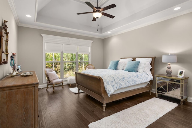 bedroom with a raised ceiling, ornamental molding, dark hardwood / wood-style floors, and ceiling fan