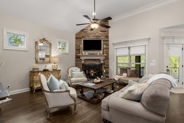 living room with lofted ceiling, dark hardwood / wood-style floors, a stone fireplace, and a wealth of natural light