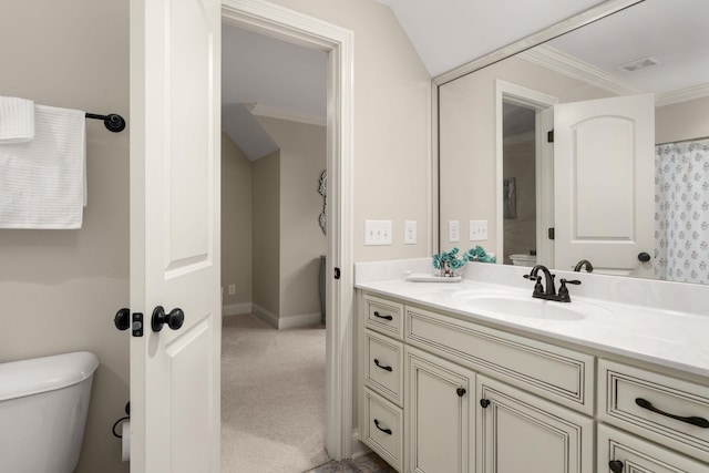 bathroom with ornamental molding, vanity, and toilet