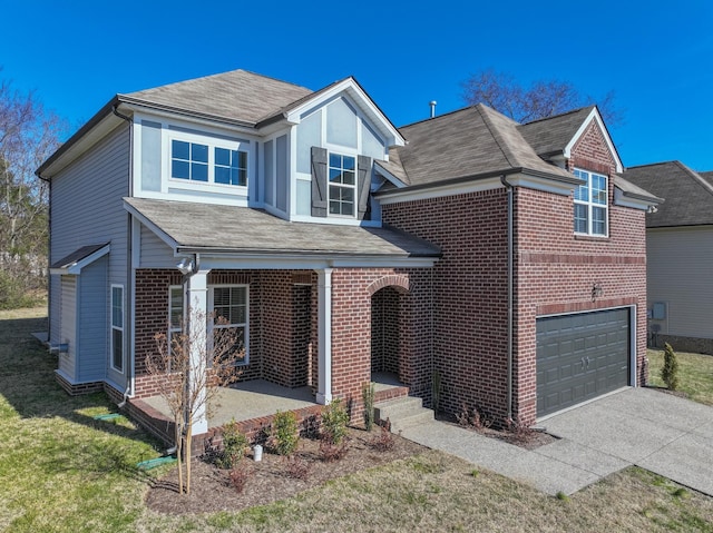 view of front of house featuring a garage, covered porch, and a front lawn