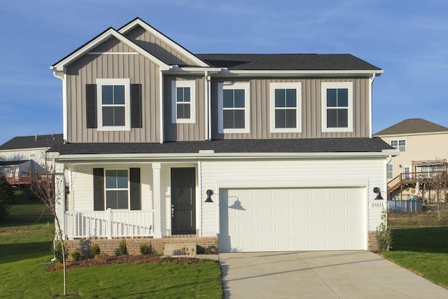 view of front of property featuring a garage, covered porch, and a front lawn