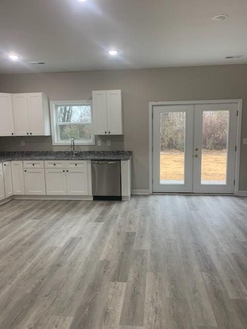 kitchen with dishwasher, light hardwood / wood-style flooring, white cabinets, and french doors