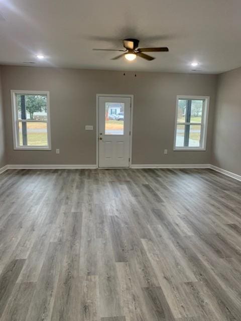 foyer entrance with ceiling fan, plenty of natural light, and light hardwood / wood-style flooring