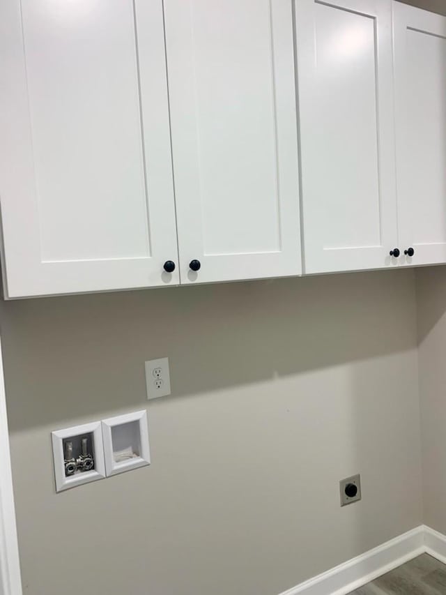 clothes washing area with electric dryer hookup, hookup for a washing machine, cabinets, and hardwood / wood-style flooring