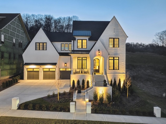 view of front of house featuring a porch and a garage