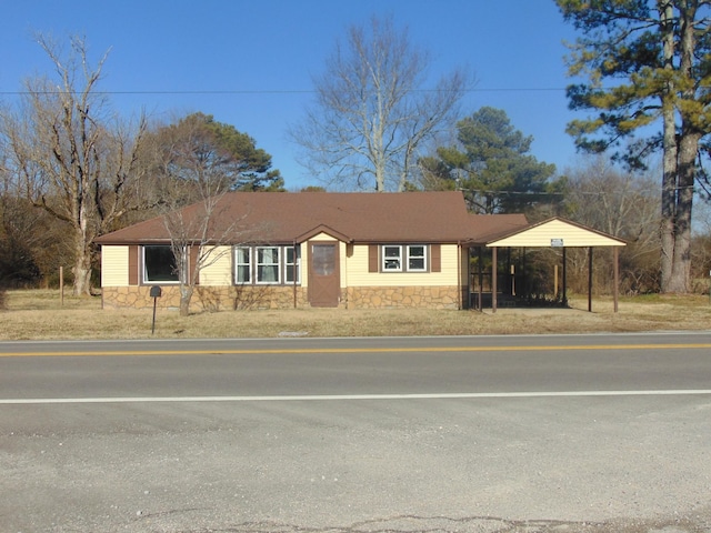 ranch-style house featuring a carport