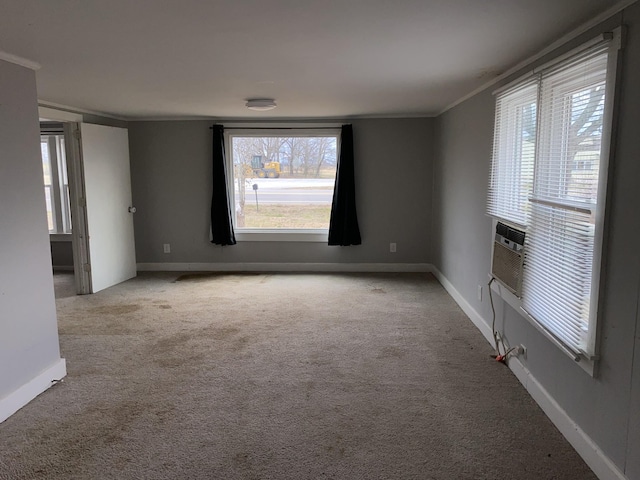 unfurnished living room featuring light colored carpet, ornamental molding, and a wealth of natural light