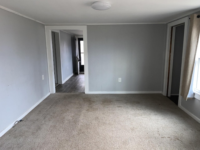 carpeted empty room featuring ornamental molding