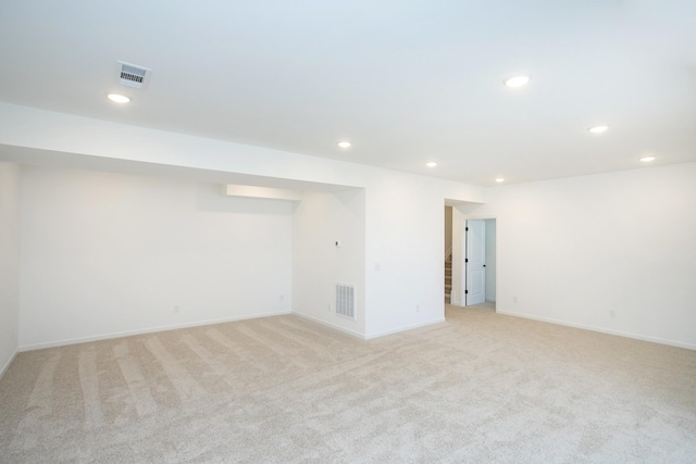 basement featuring light carpet