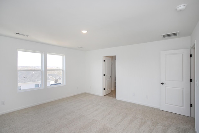 spare room with light colored carpet