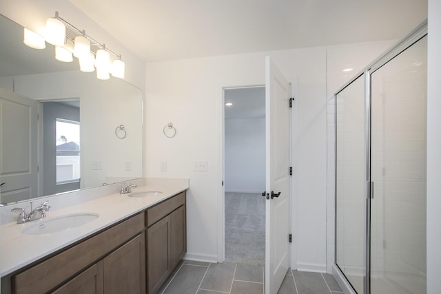 bathroom featuring walk in shower, vanity, and tile patterned flooring