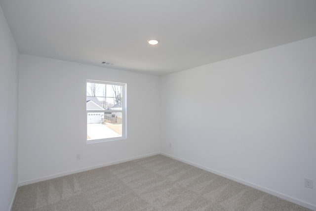 unfurnished room with light carpet