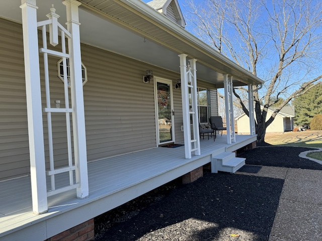 wooden terrace featuring covered porch