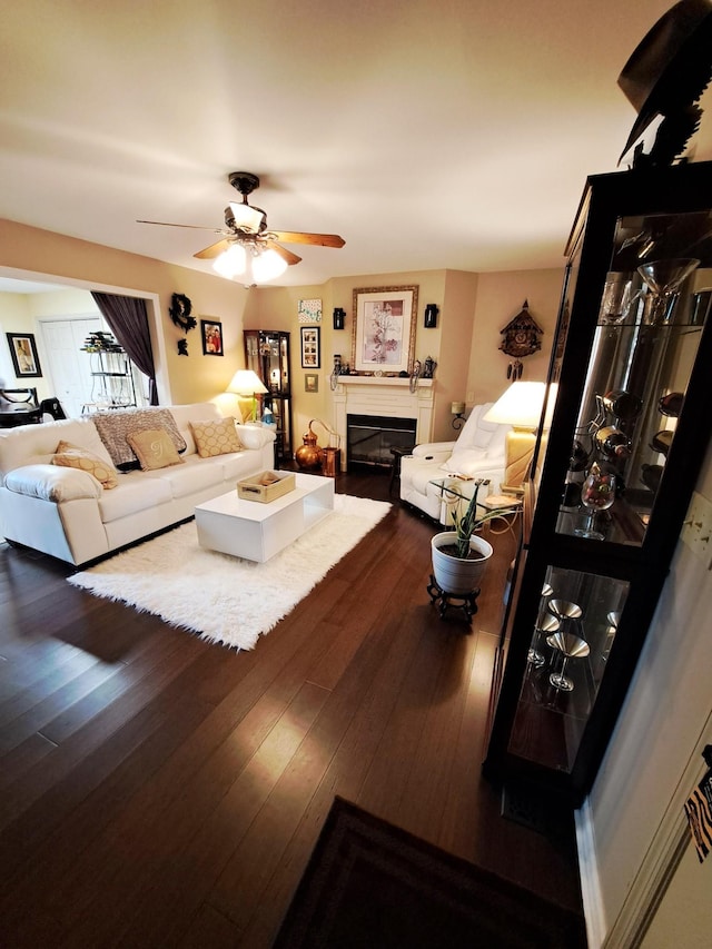 living room with dark hardwood / wood-style floors and ceiling fan