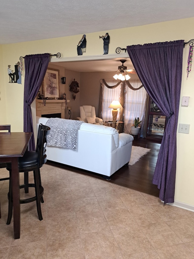 living room with light tile patterned floors and ceiling fan