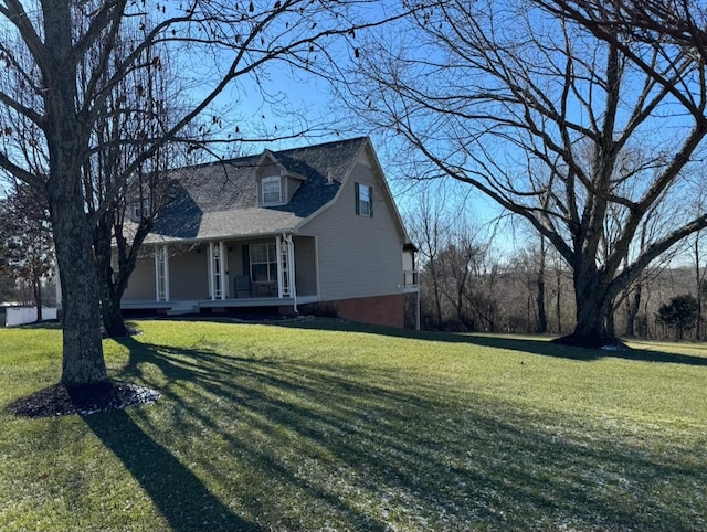 cape cod home featuring a front lawn and covered porch