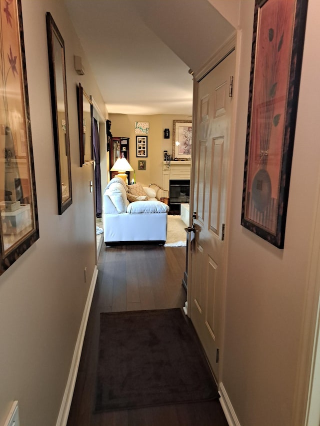 corridor with dark hardwood / wood-style floors