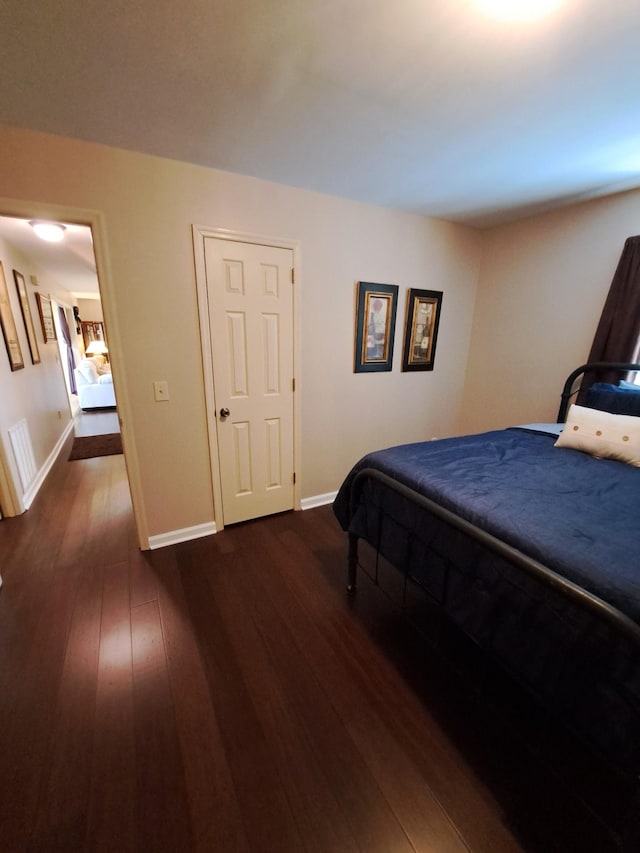 bedroom featuring dark hardwood / wood-style flooring