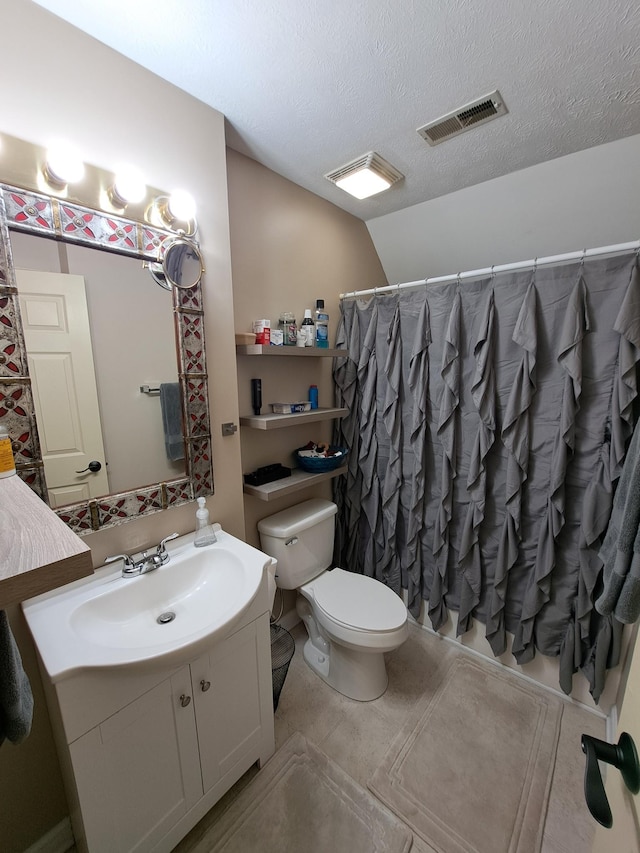 bathroom with lofted ceiling, toilet, a shower with curtain, a textured ceiling, and vanity