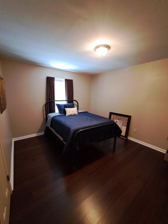 bedroom featuring dark wood-type flooring