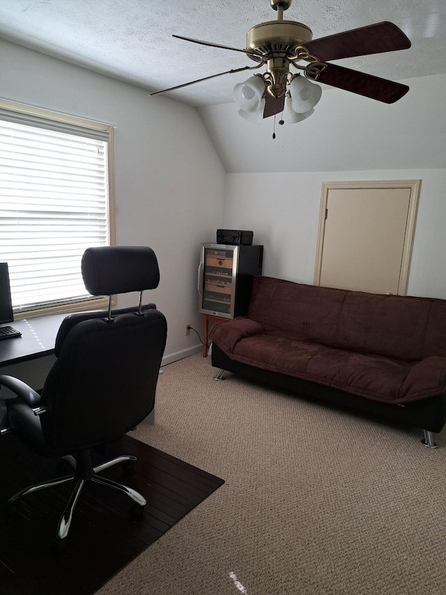 office with ceiling fan, lofted ceiling, carpet floors, and a textured ceiling