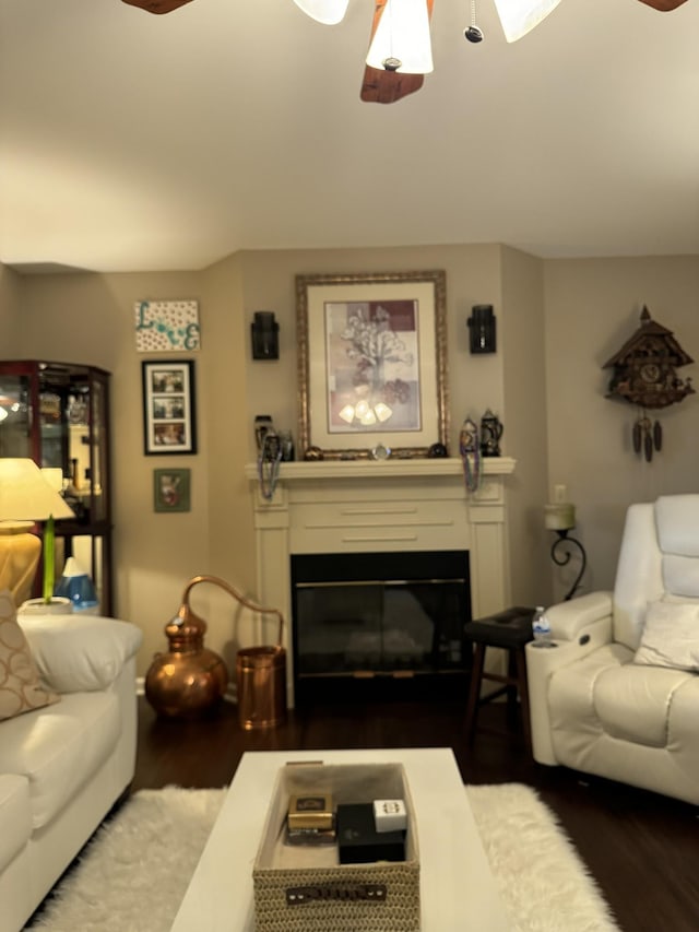 living room with ceiling fan and dark hardwood / wood-style flooring