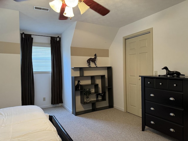 bedroom with lofted ceiling, light carpet, and ceiling fan