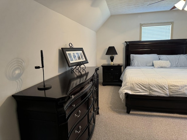 carpeted bedroom with ceiling fan and vaulted ceiling